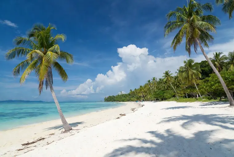 White Sand Beach on Koh Chang with palm trees and turquoise water