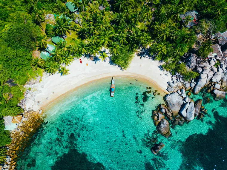 Long white sand Chaweng Beach on Koh Samui with turquoise water and palm trees