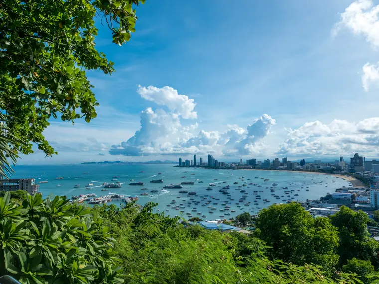 Jomtien Beach in Pattaya with sandy shore, palm trees and high-rise hotels