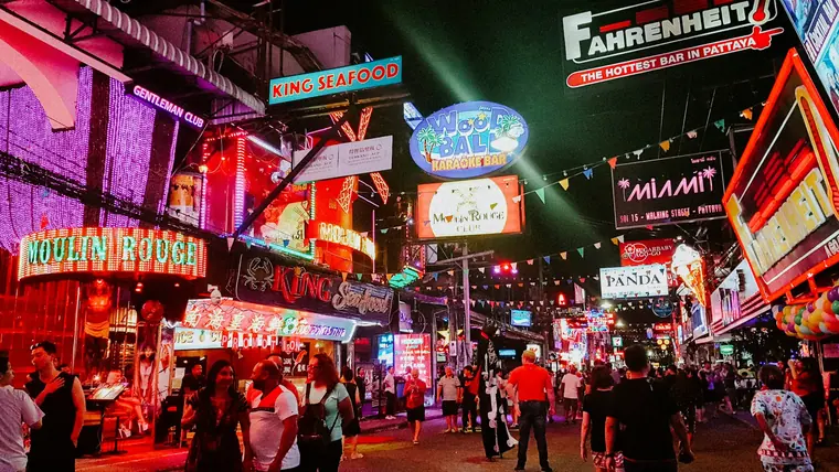 Neon-lit Walking Street in Pattaya at night with crowds and colourful signs