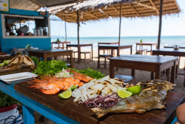 Fresh grilled seafood including prawns, squid and fish at a beachside restaurant in Rayong