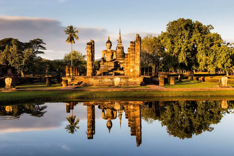 Dawn light and still water at Sukhothai Historical Park, the first Siamese capital