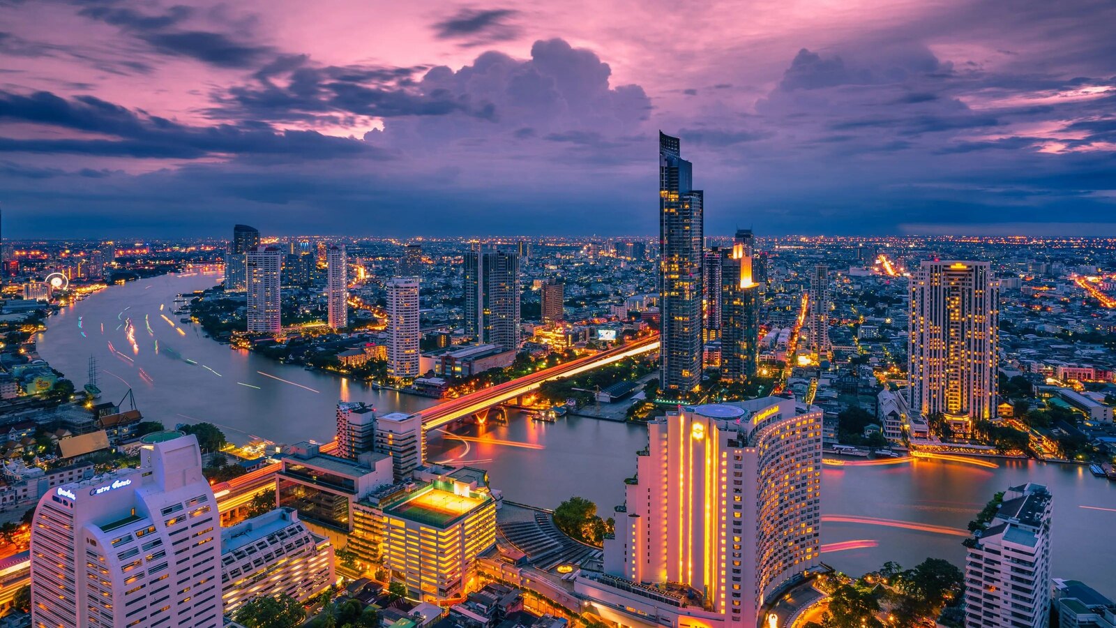 Bangkok skyline at dusk with the Chao Phraya River and lit high-rise towers, the gateway city in this Thailand tourism update