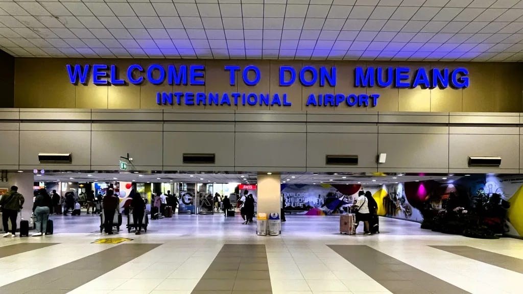 Blue welcome sign reading Don Mueang International Airport above the arrivals concourse, one of two Bangkok gateways for anyone planning to travel to Thailand