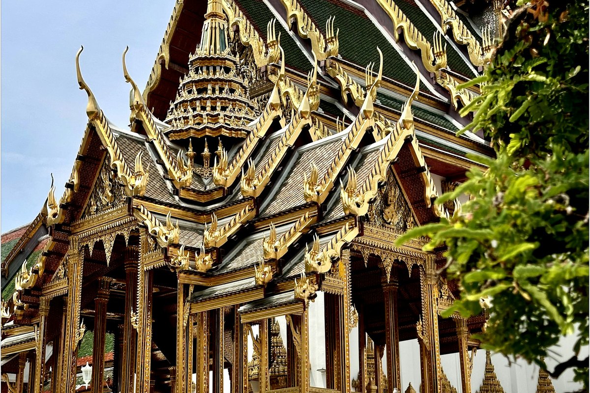 Golden spires and tiered roofs of the Grand Palace in Bangkok, one of the landmarks the royal barges pass on their Chao Phraya River route