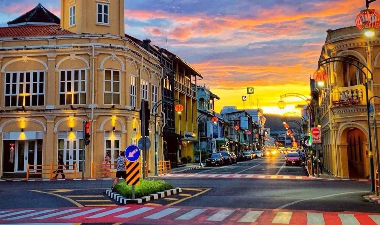 Thalang Road in Phuket Old Town at dusk, Sino-Portuguese shophouses strung with red Chinese lanterns before the Vegetarian Festival, one of the biggest Thai festivals 2026 events
