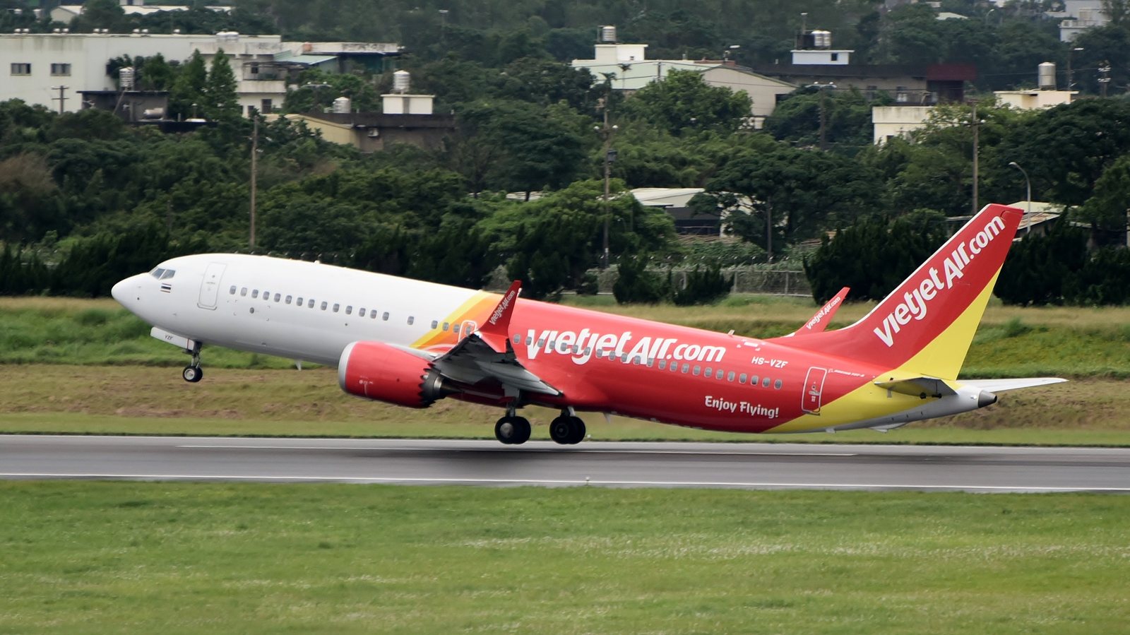 A Thai VietJet Air Boeing 737-8 in red and yellow livery lifting off from the runway, the aircraft type now flying the new daily Kuala Lumpur to Bangkok route in the latest Thailand travel news