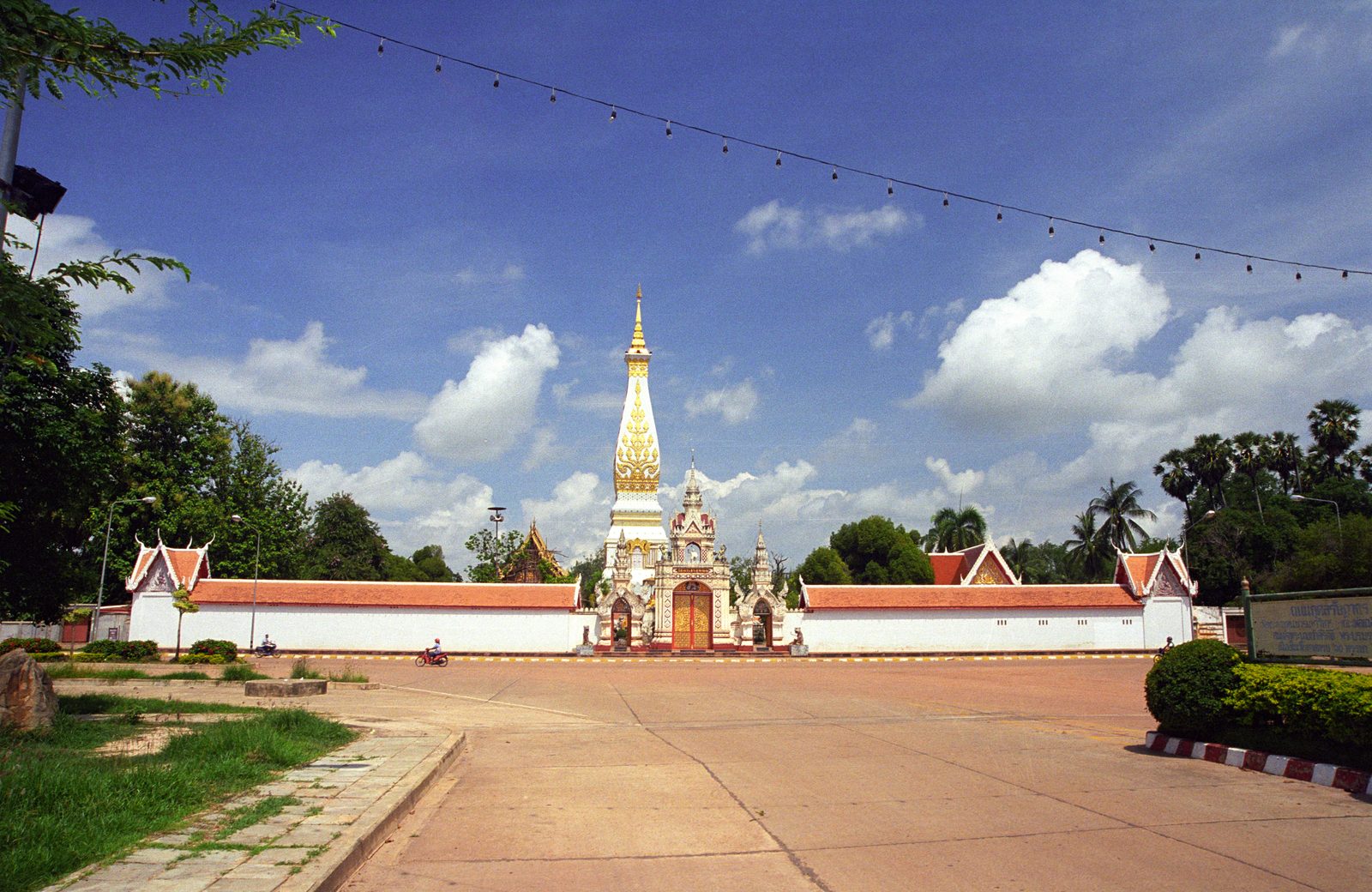 The white and gold chedi of Wat Phra That Phanom rising above its cloister walls in Nakhon Phanom province, one of the most venerated stupas in Isan and a highlight of Thai culture