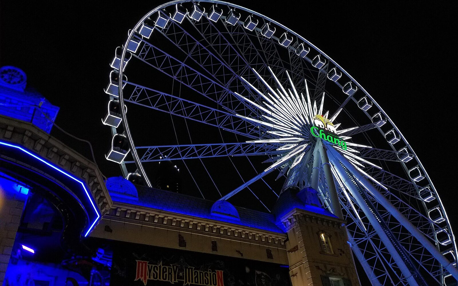 The illuminated Sky ferris wheel at Asiatique The Riverfront on the Chao Phraya in Bangkok at night, a free-entry night market and Bangkok tourism landmark