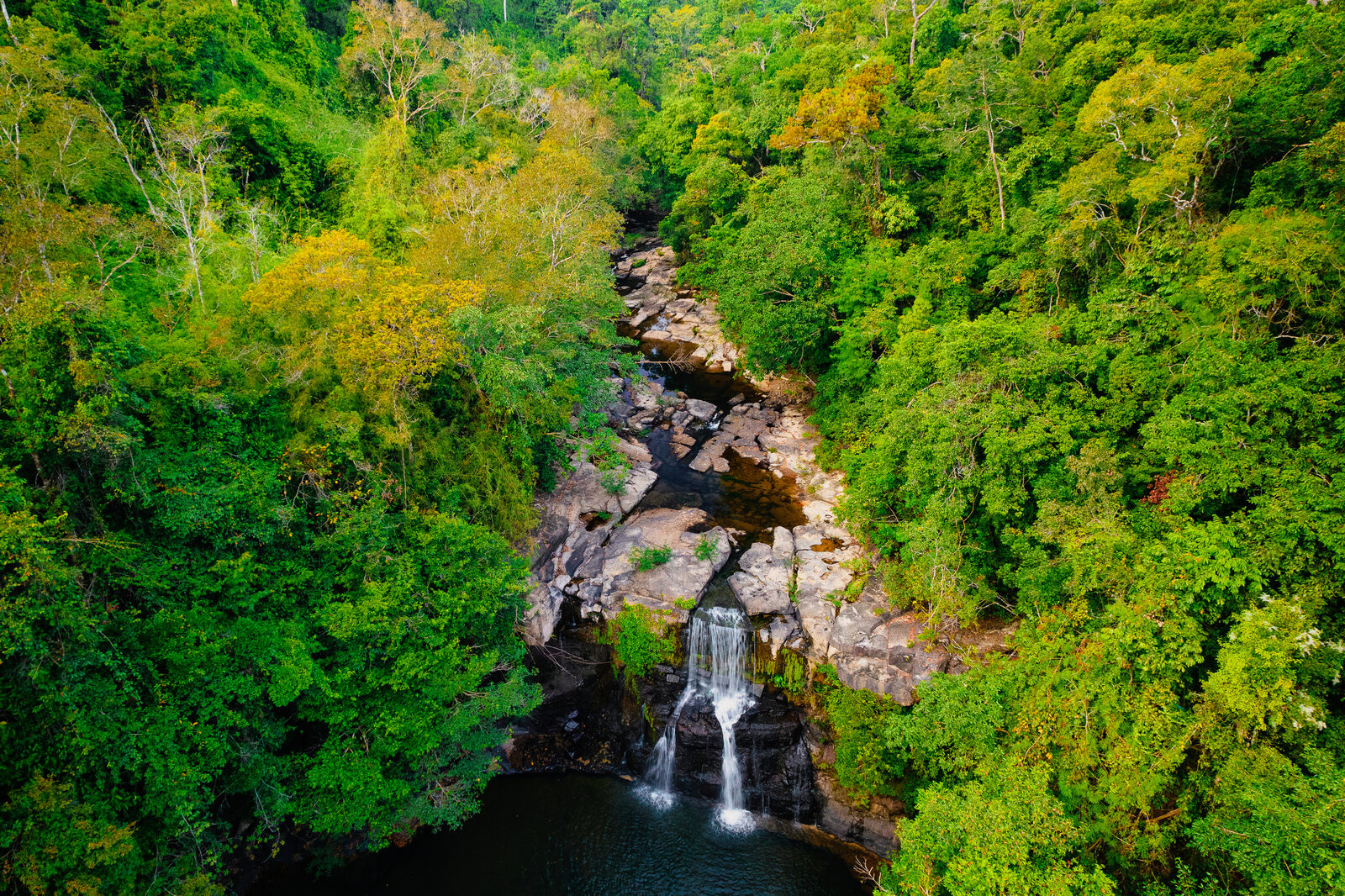 Aerial view of Khlong Chao waterfall on Koh Kood in Mu Ko Chang National Park, a three-tier fall surrounded by rainforest, a highlight of Koh Kood travel