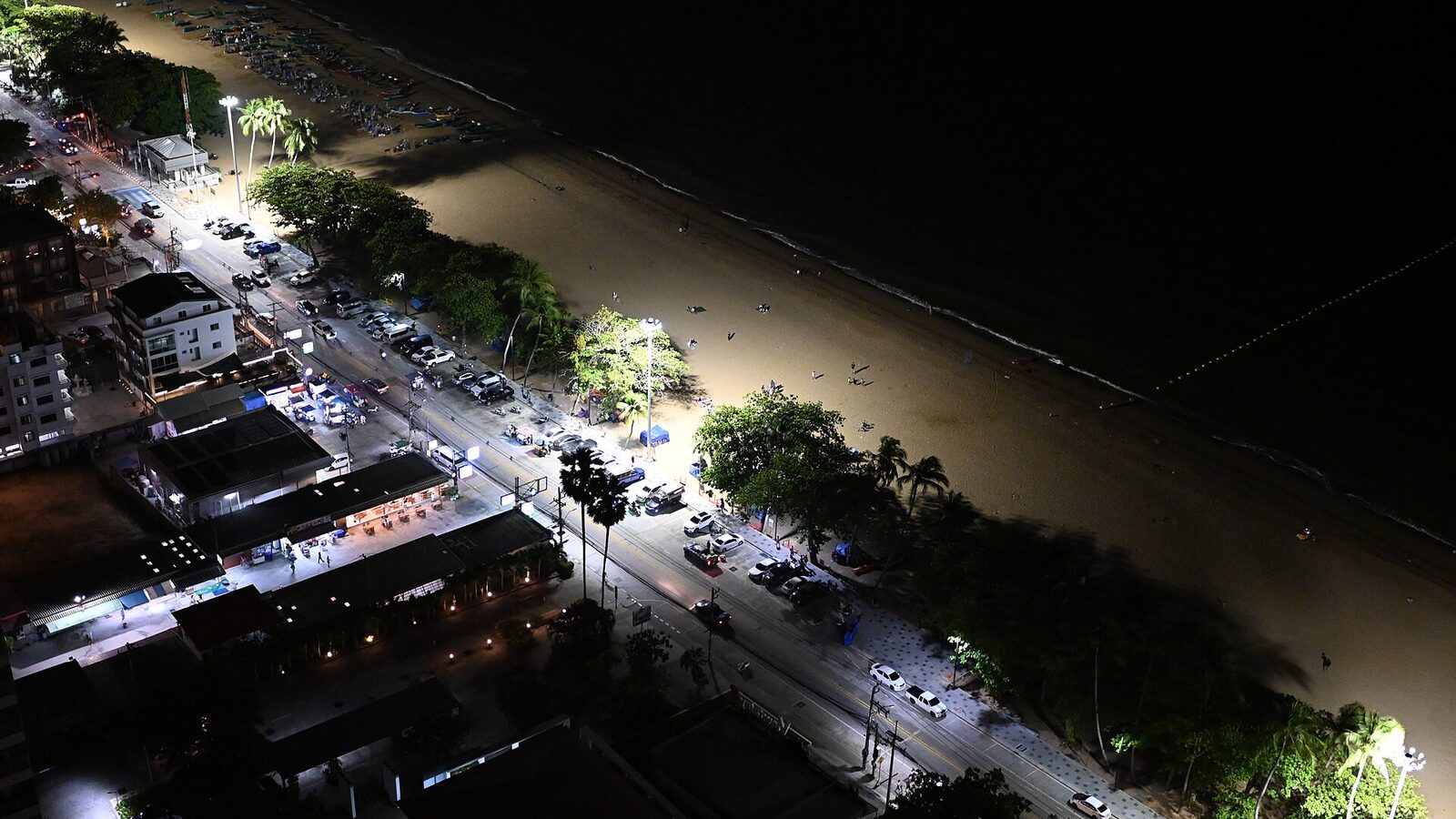 Night-time aerial view of Pattaya Beach Road, the lit beachfront promenade and the curve of sand along the Gulf of Thailand, the stretch closed to traffic for the fireworks festival