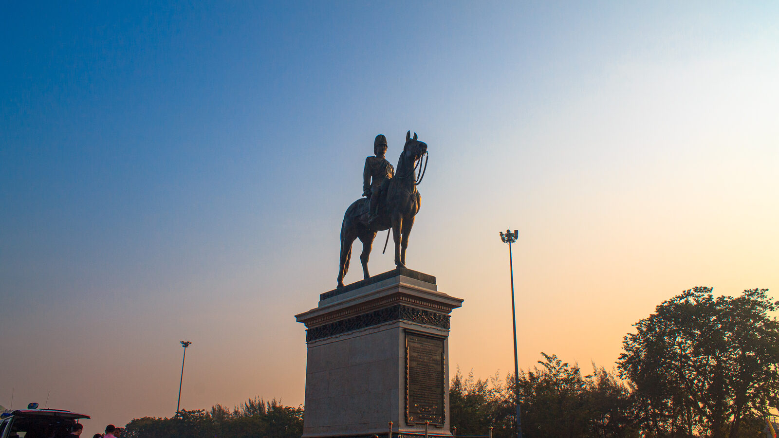 The bronze equestrian statue of King Chulalongkorn silhouetted against a sunset sky at the Royal Plaza in Dusit, Bangkok, the focus of Chulalongkorn Memorial Day in this Thailand travel news update