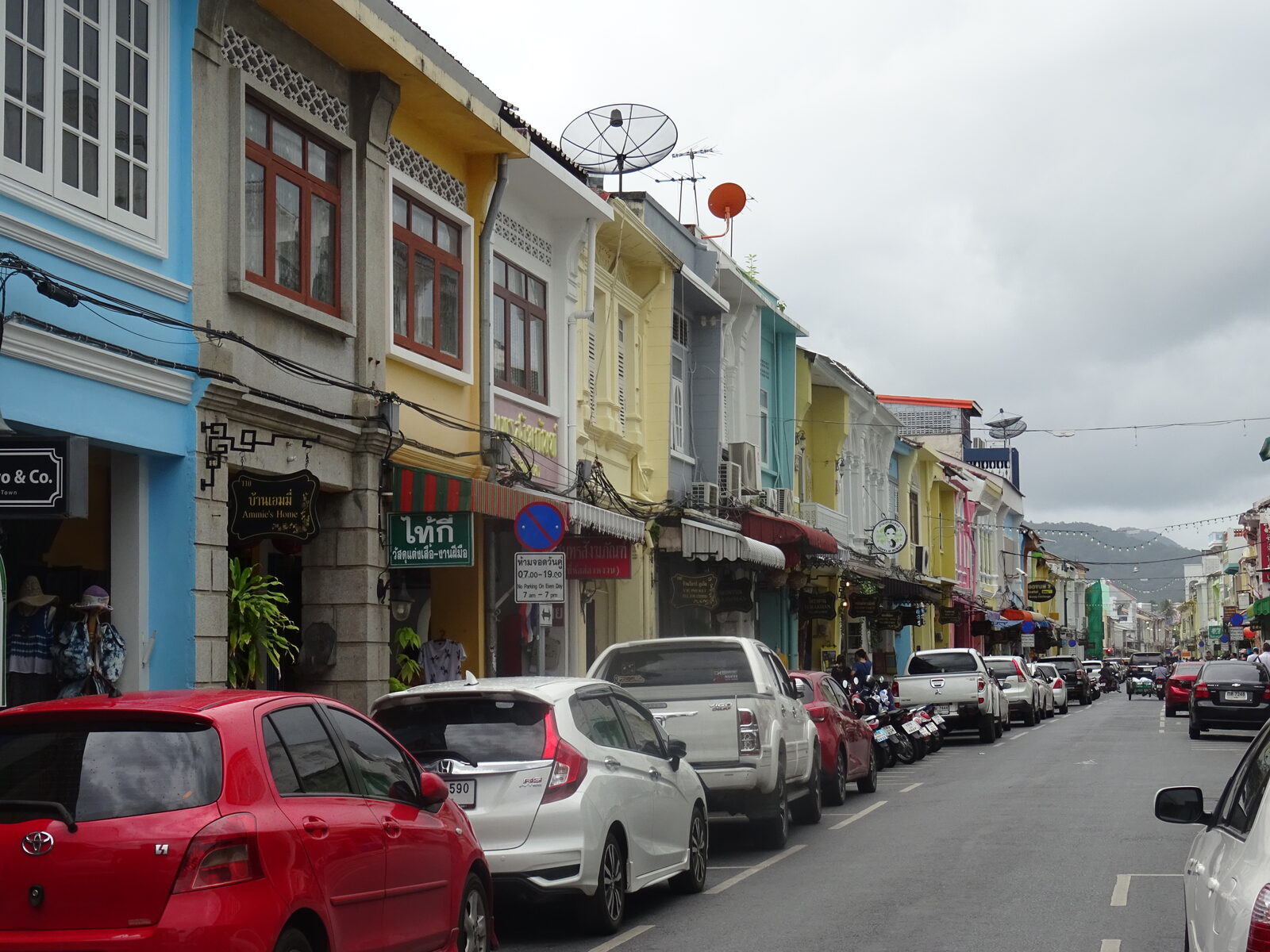 Pastel Sino-Portuguese shophouses with shuttered windows lining Thalang Road in Old Phuket Town, a living record of Thai culture and Peranakan heritage on the island