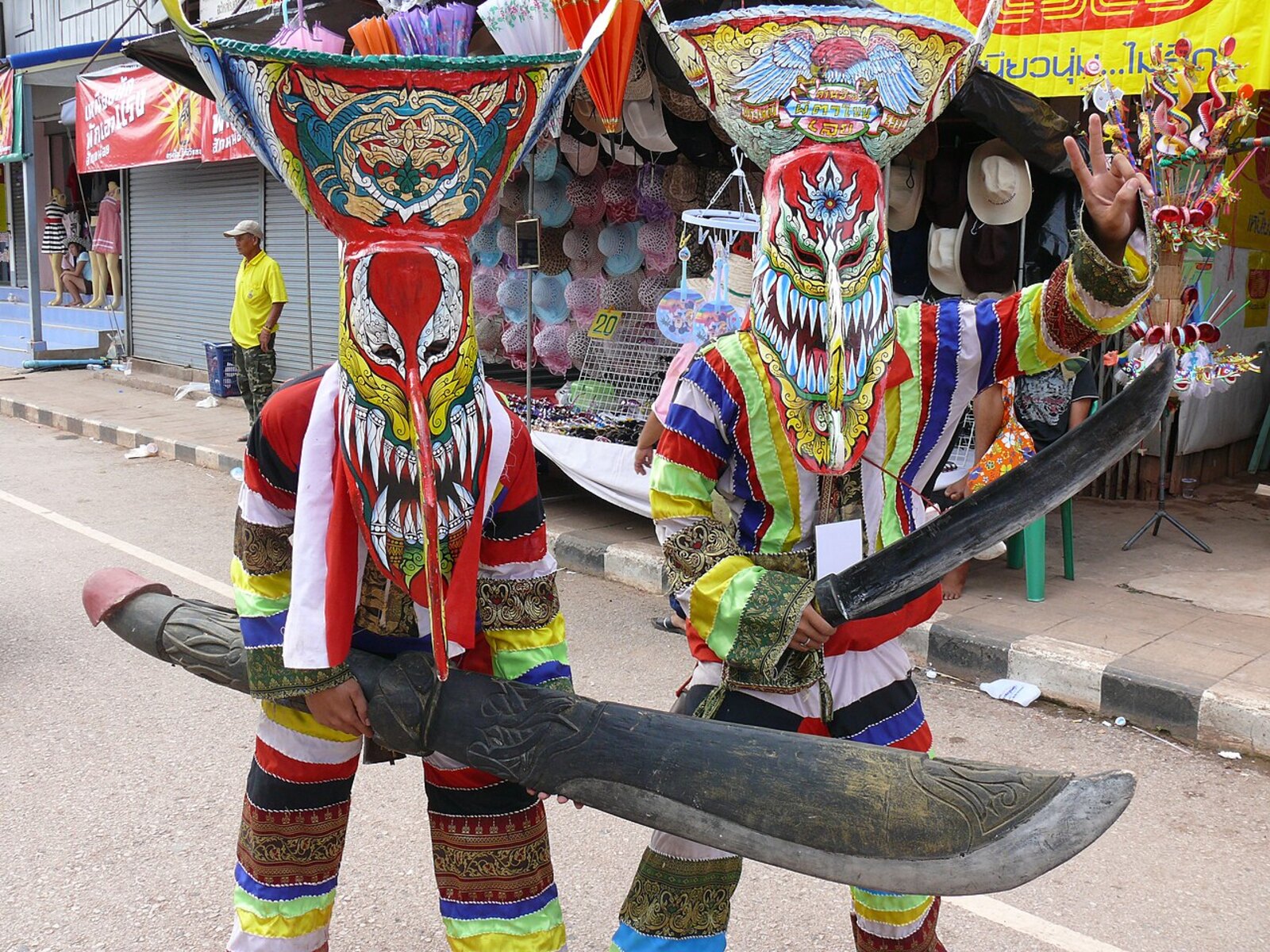 A row of tall, brightly painted Phi Ta Khon ghost masks from the Dan Sai festival in Loei, an example of the Thai culture behind Thailand's spirit parades