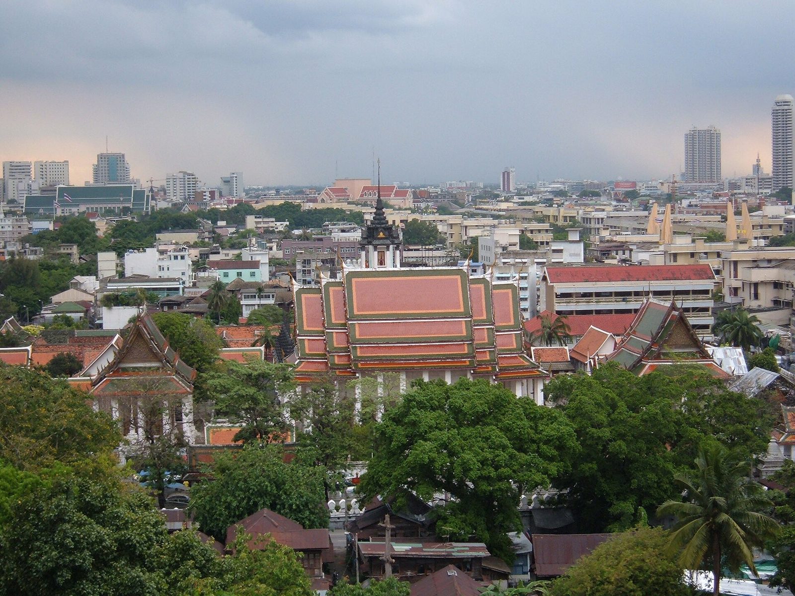 View west from the Golden Mount terrace over Bangkok's Old Town rooftops toward Wat Ratchanatdaram, a Thai culture highlight of Bangkok tourism