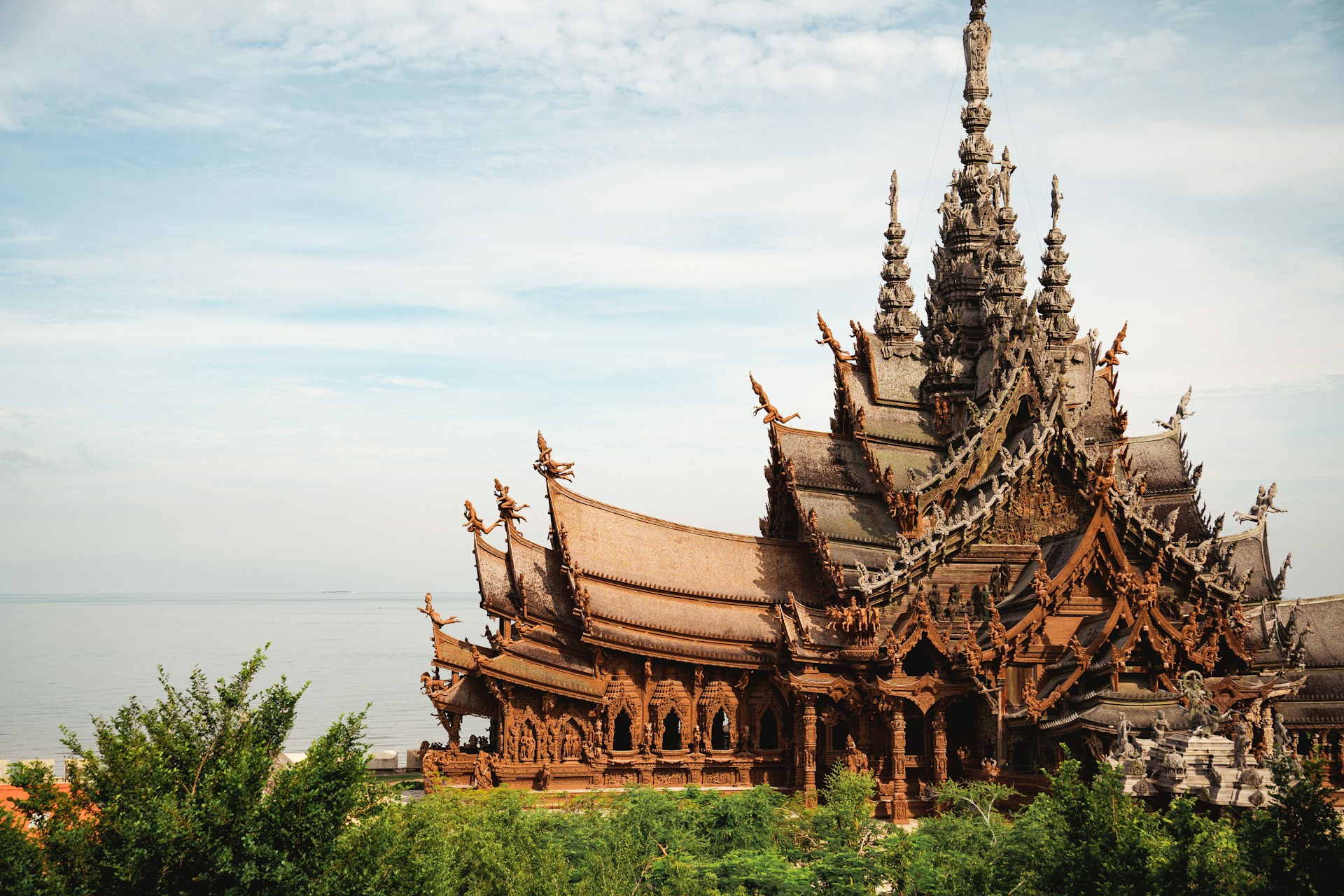 The elaborate wooden Sanctuary of Truth in Pattaya under dramatic skies