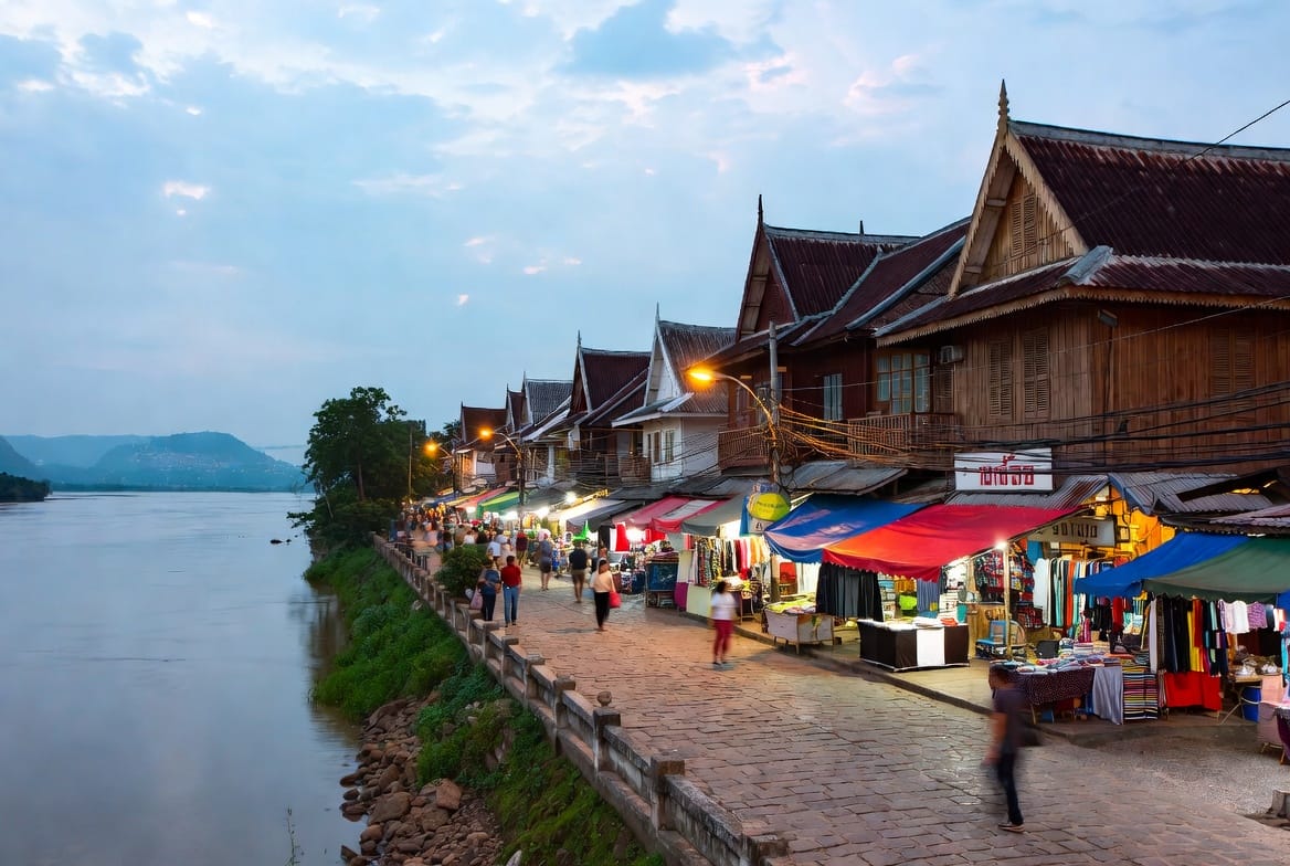 Chiang Khan Walking Street with wooden shophouses and evening market stalls along the Mekong