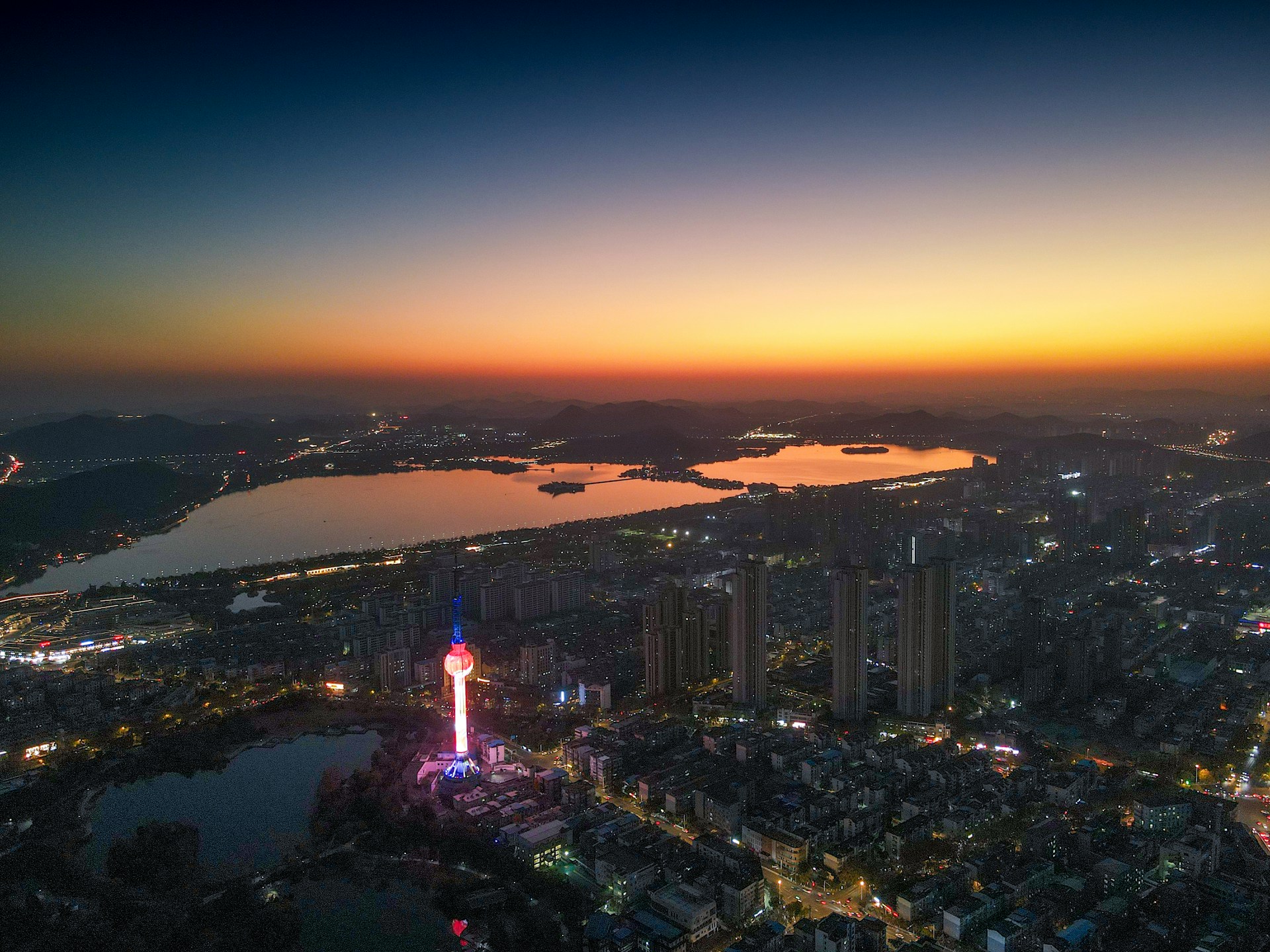 Nong Prajak Park lake in Udon Thani with walking paths and city skyline