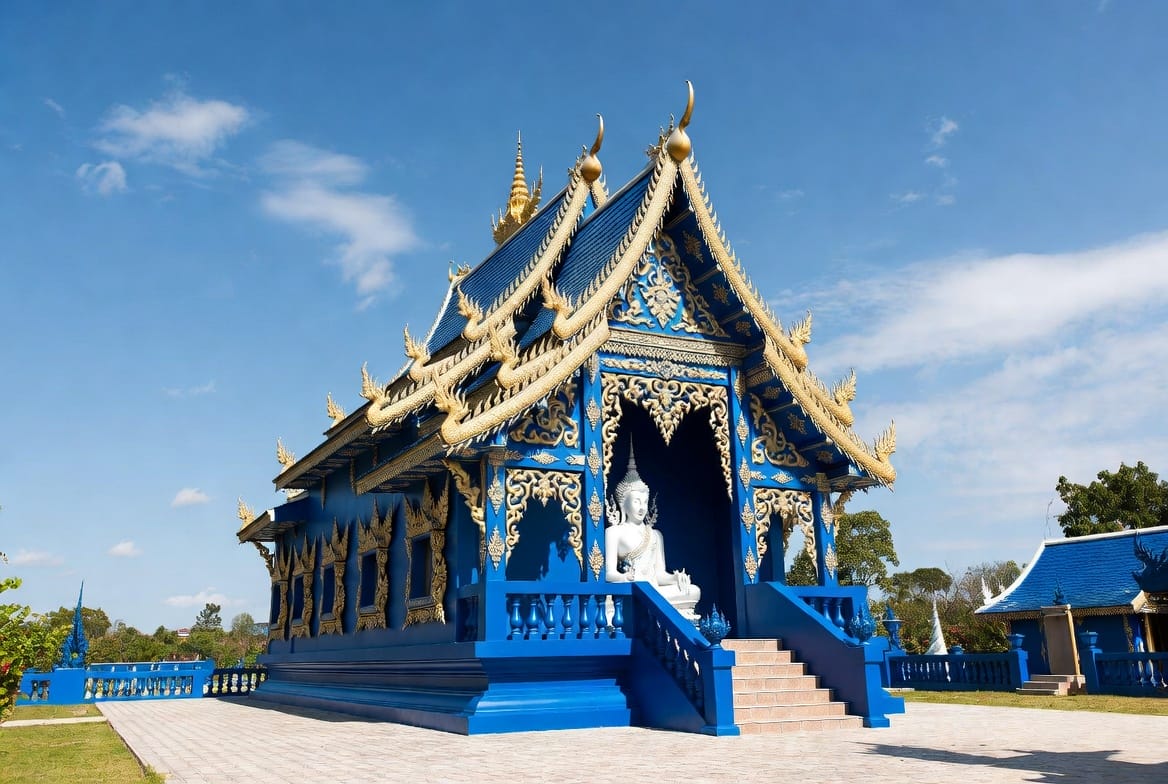 The striking blue exterior of Wat Rong Suea Ten, the Blue Temple in Chiang Rai