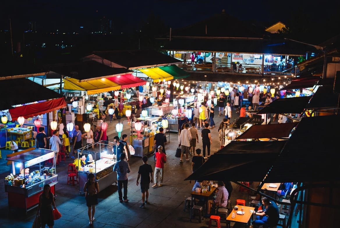 Lively night market scene in Hua Hin with food stalls and colourful lights