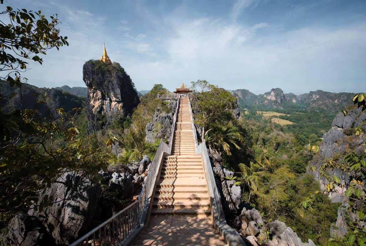 Steep staircase leading to Tiger Cave Temple viewpoint in Krabi with golden chedi