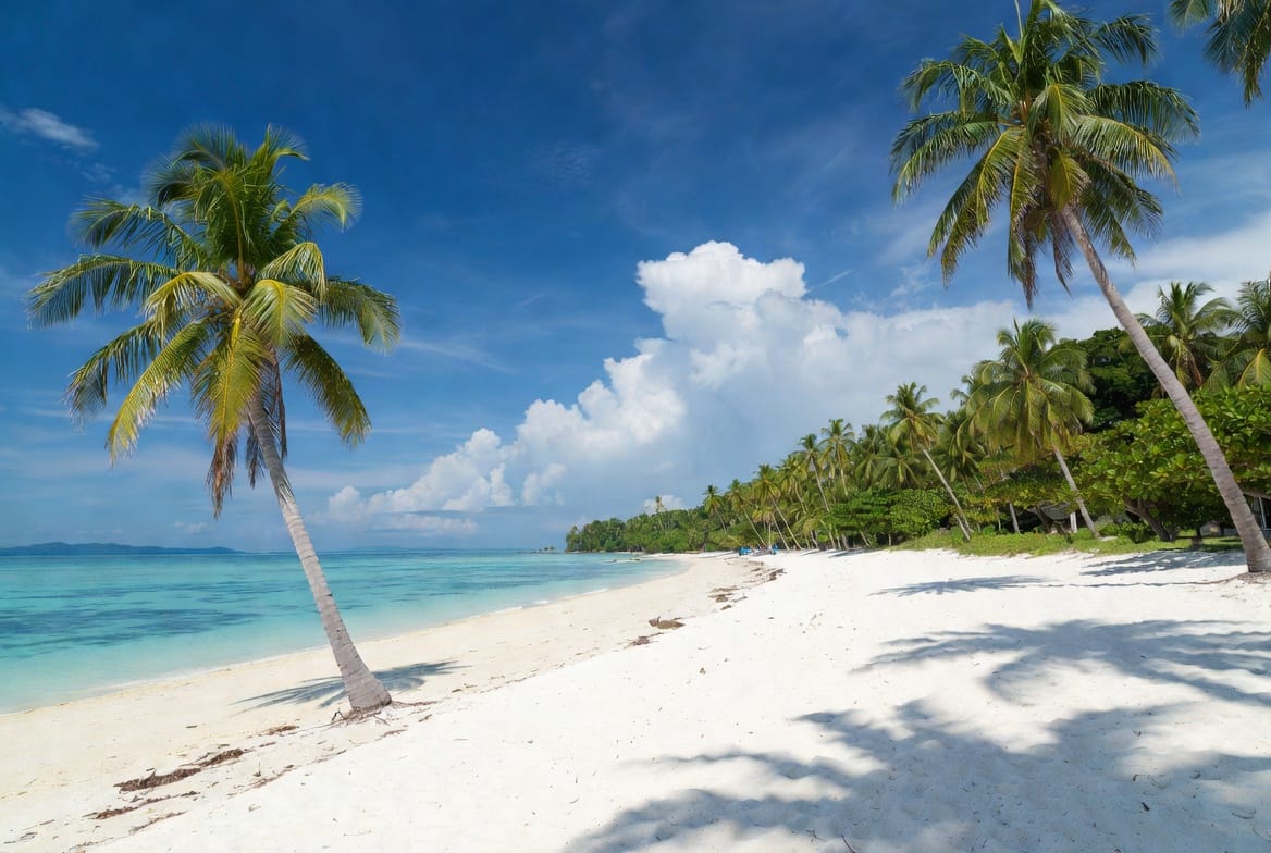 White Sand Beach on Koh Chang with palm trees and turquoise water