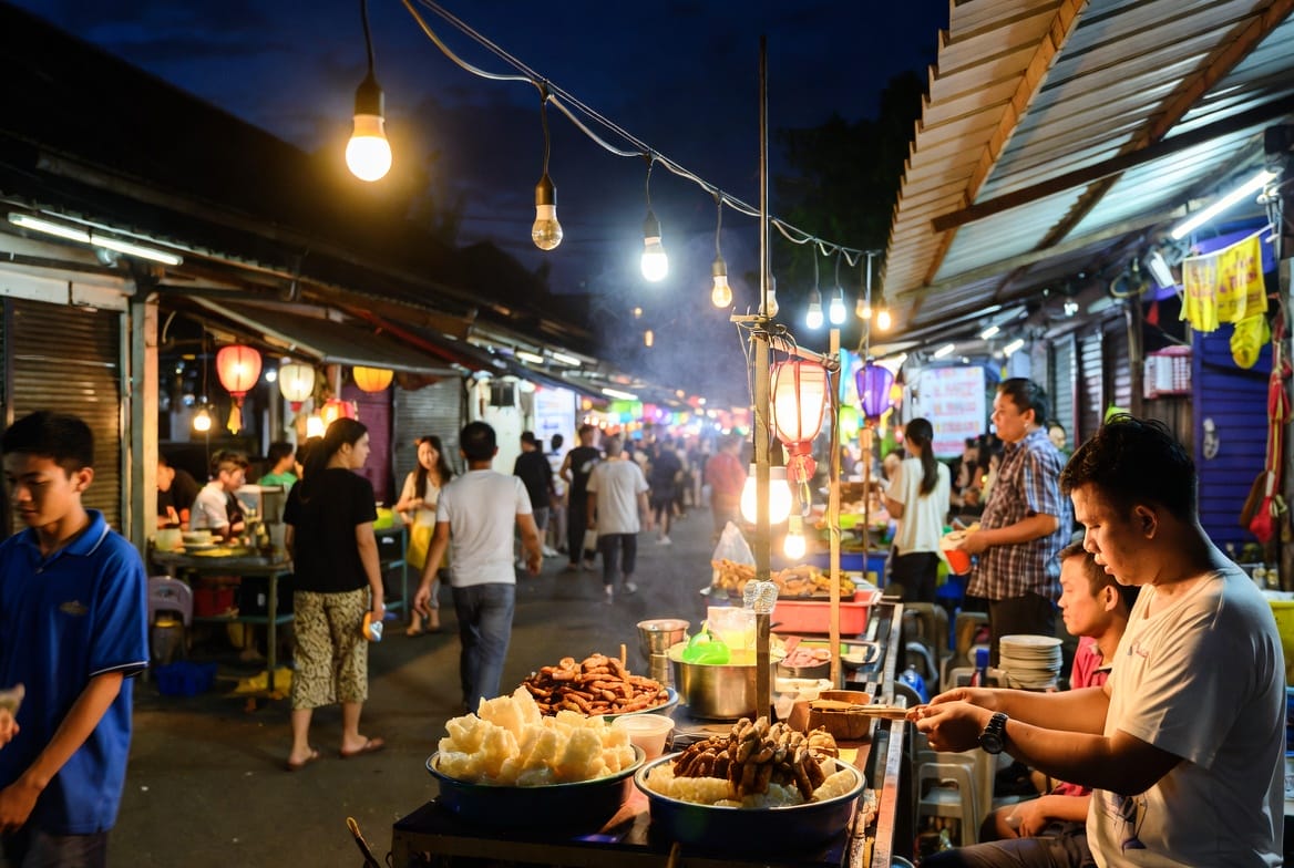 Khon Kaen night market with food stalls, lights and local people eating