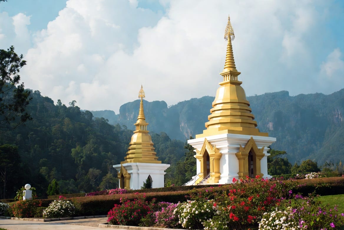 Twin Royal Pagodas on Doi Inthanon with mountain backdrop and flower gardens