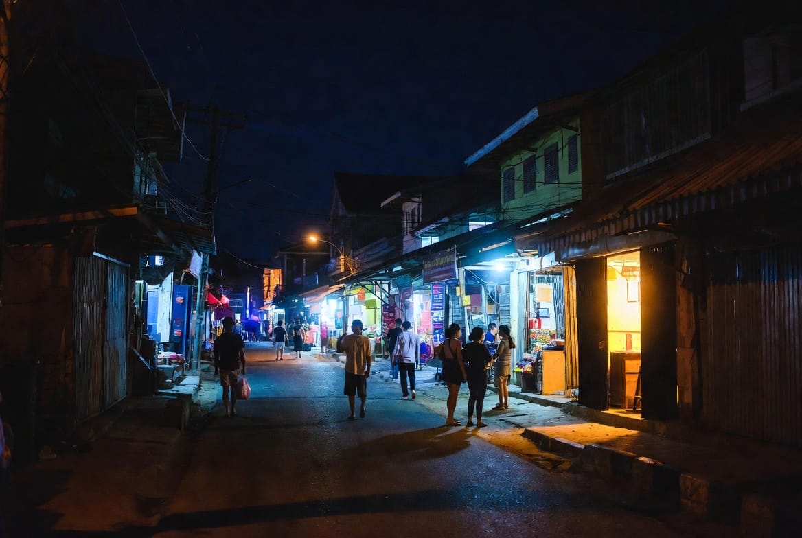 Evening street scene in Trat town with people and local shops