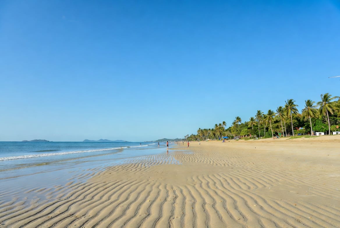 Wide sandy Mae Ramphueng Beach in Rayong with calm sea and palm trees