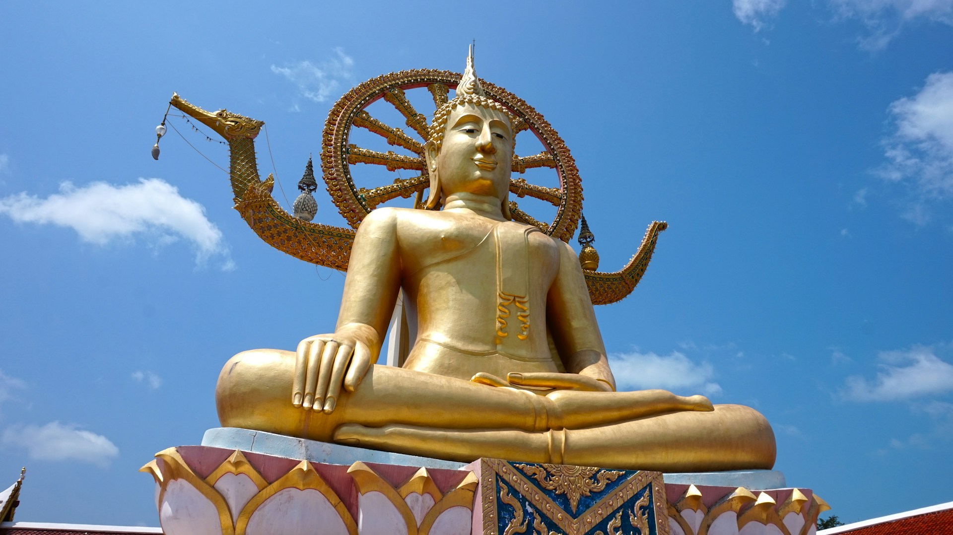 Golden Big Buddha statue on a rocky islet on Koh Samui