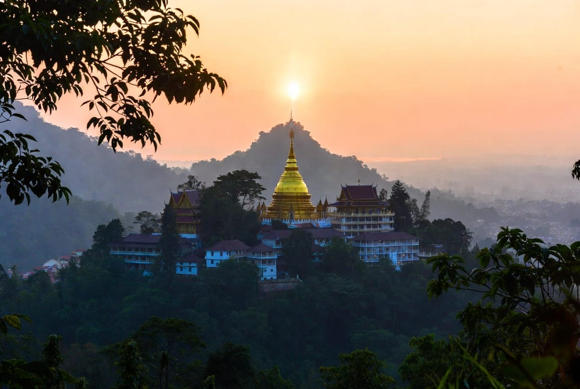 Wat Phra That Doi Suthep glowing at sunrise above Chiang Mai