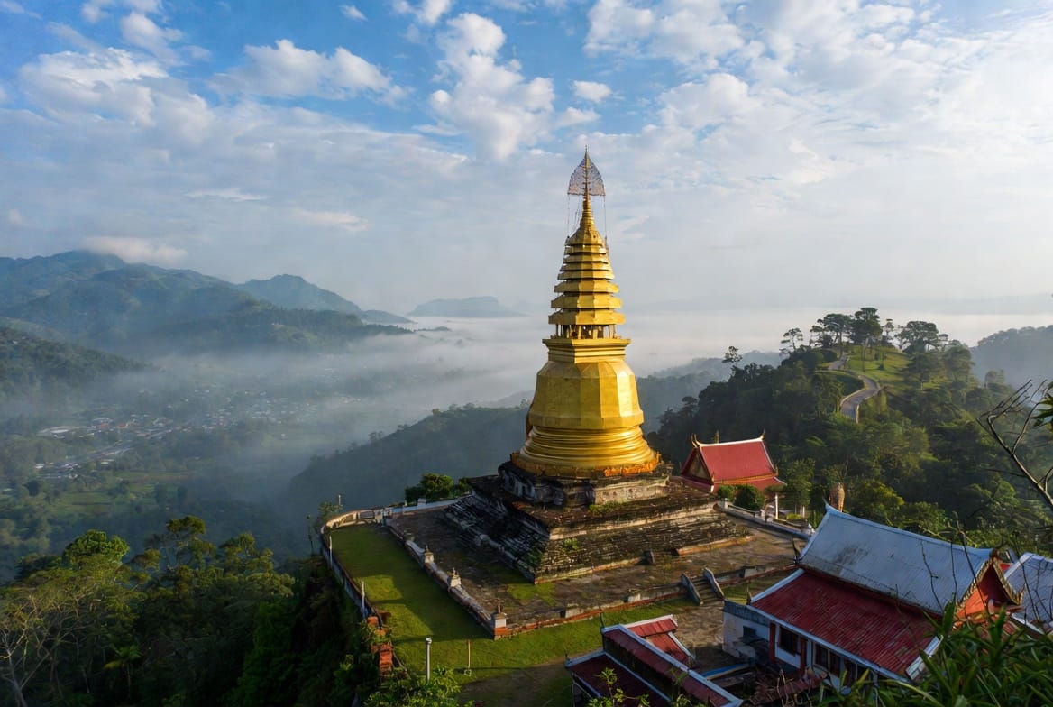 Golden chedi of Wat Phra That Doi Kong Mu overlooking the misty Mae Hong Son valley