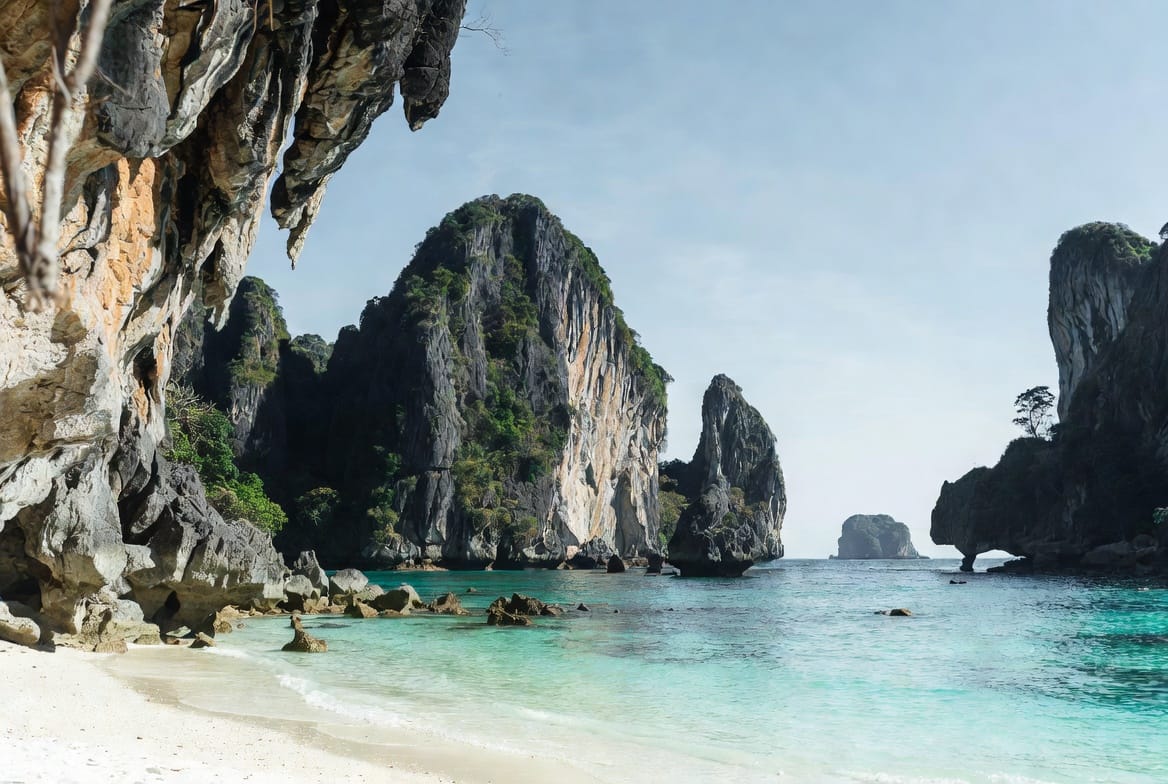 Railay Beach in Krabi with dramatic limestone cliffs and clear turquoise water