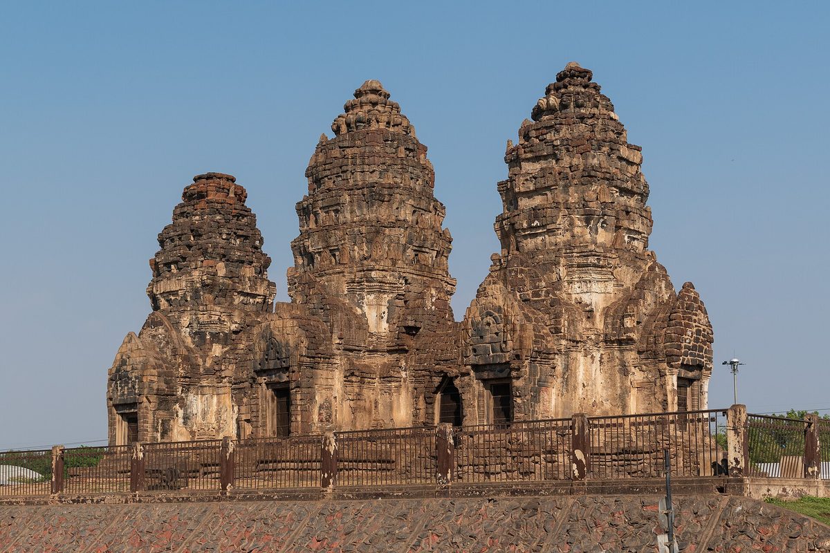 The three Khmer towers of Phra Prang Sam Yot in Lopburi seen from the road