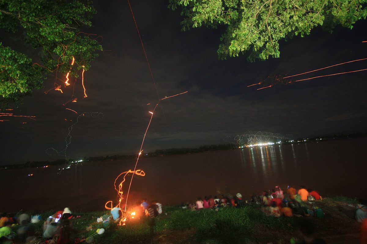 Spectators gathered along the Mekong river at night during the Naga Fireballs festival in Nong Khai