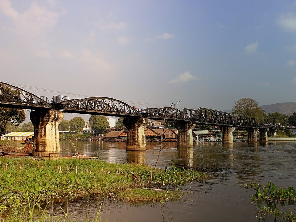 The steel railway bridge spanning the River Kwai in Kanchanaburi by day