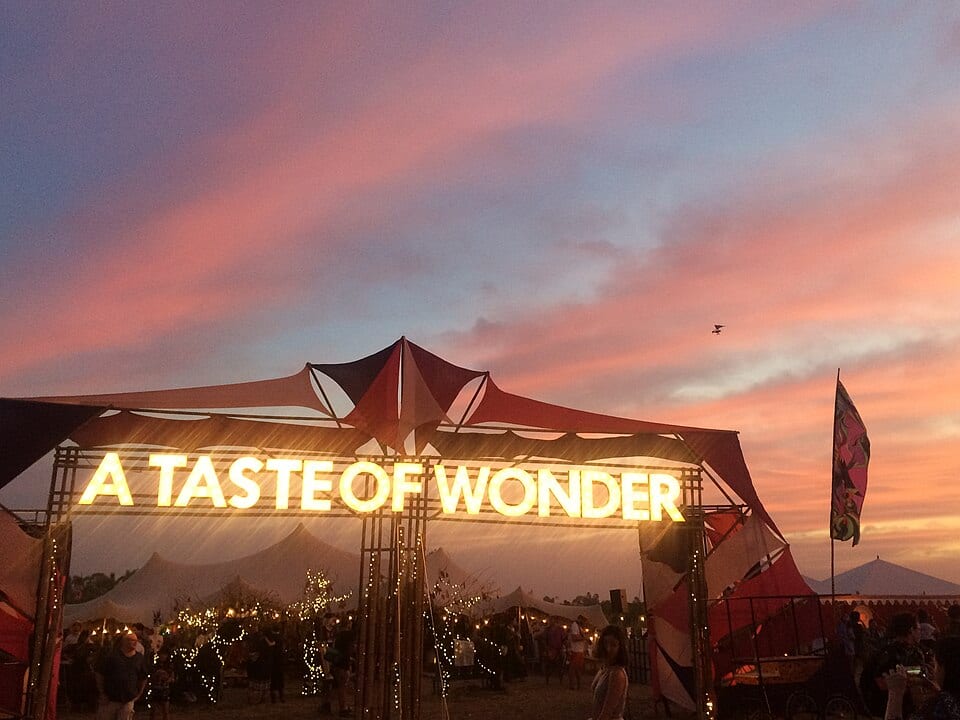The A Taste of Wonder entrance at Wonderfruit 2015 against a sunset sky